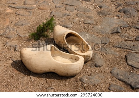 Old peasant shoes carved from wood, built on a rocky road