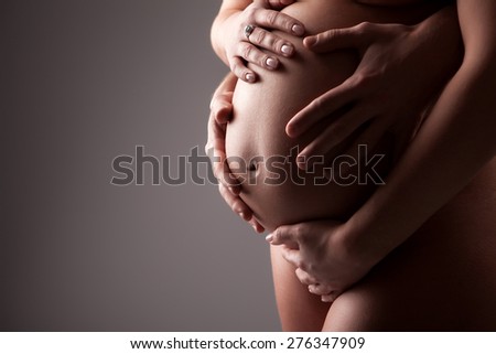 Hands on a stomach of the pregnant woman