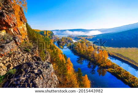 Panoramic view of the river valley in autumn. Autumn river in mountain valley. Autumn river valley panorama. River valley in autumn