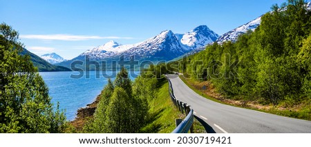 The road along the mountain lake. Mountain road panorama. Mountain road panoramic landscape. Road in mountains