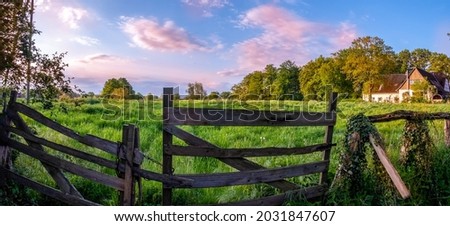 Wooden fence on the farm. Farm fence view. Wooden farm fence. Fence in farm land