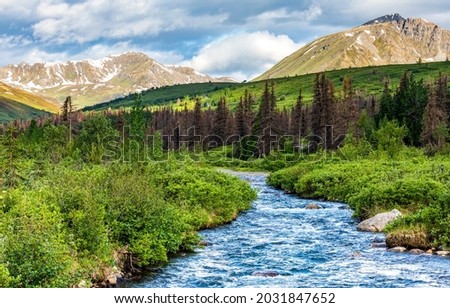 A river in a mountain valley. Mountain river valley landscape. Mountain river view. River valley in mountains