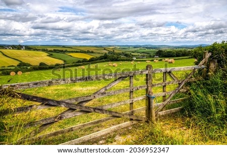 Wooden fence in agricultural land. Farm field fence. Fence in farm field