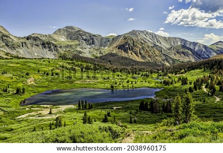 A small lake in a mountain valley. Lake in mountain valley. Mountain valley lake landscape
