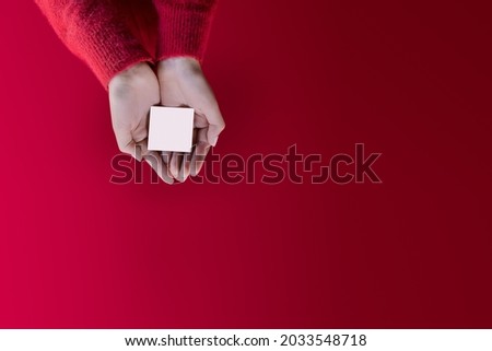 Promo template christmas card. Female hands with customizable emty space on red background Photo stock © 