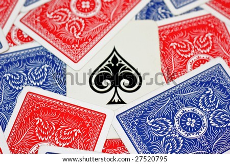 Red and blue [playing card scattered around the ace of spades