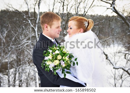 Romantic happy bride and groom on winter wedding day