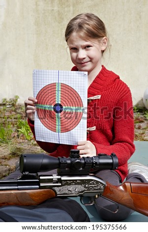 Girl with a target and a pneumatic gun. Sport shooting