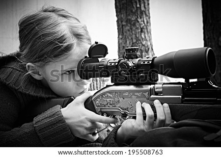 Girl aiming a pneumatic gun. Sport shooting
