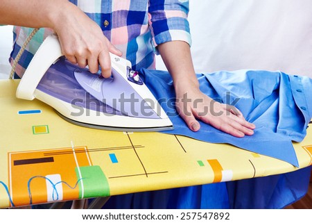 Woman ironed men's shirt close-up
