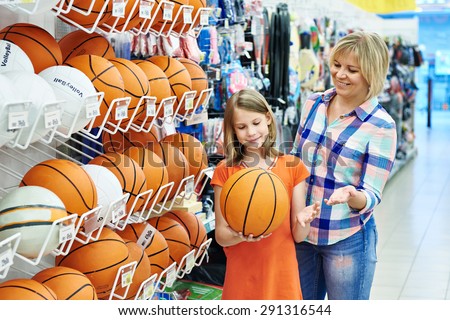 Mother and daughter shopping basketball ball in sport shop