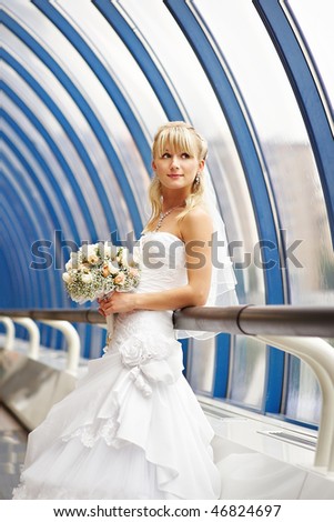 Happy bride with wedding bouquet on the Bridge Business Center