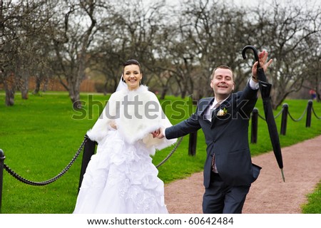 Funny couples in wedding walk in park