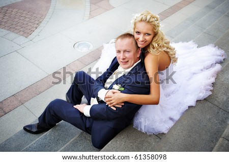 Bride and groom on steps of palace at wedding day