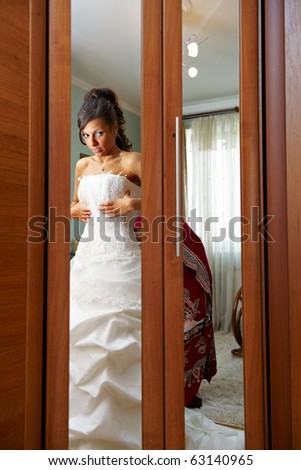 Charges the bride and dress up wedding gown in house of parents