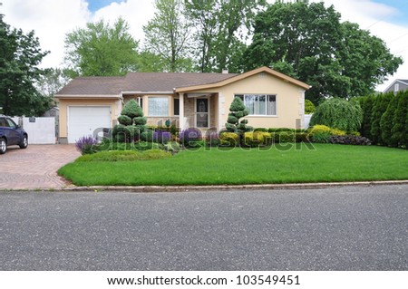 Stock Photo Beautifully Landscaped Suburban One Story Home In Residential Neighborhood 103549451 