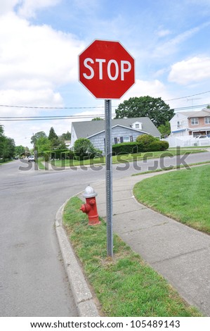 Red Stop Sign and Fire Hydrant on Suburban Neighborhood Street Corner
