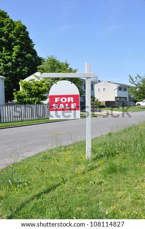 Real Estate For Sale Sign on Grass Yard Curb Suburban Neighborhood