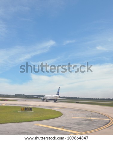 ORLANDO, FLORIDA - MAY 27: JetBlue plane landing at Orlando Airport (founded in 1999) serves 71 destinations in 21 states + 12 countries in the Caribbean, South + Latin America. Orlando May 27, 2012.
