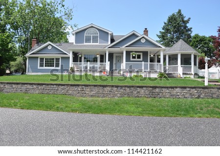 Beautiful Suburban Craftsman Cottage style Home with Landscaped Front Yard Lawn and brick wall