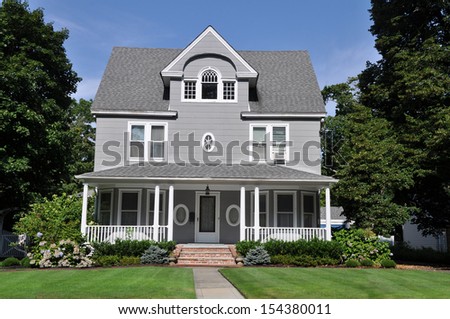 Beautiful Large Suburban Home Manicured Front yard lawn Blooming Rhododendron Flowers Shrubs Plants
