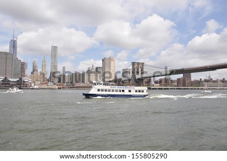 MANHATTAN, NY - JUL 14: New York Water Ways Ferry is a passenger excursion / sightseeing boat in the East River. The company has 34 boats and has a daily ridership of 30,000 people. NYC Jul 14, 2013.