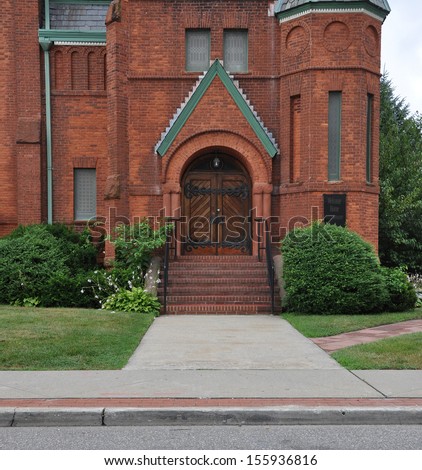 Brick Church Entrance with Sign Welcome Home Daily Worship