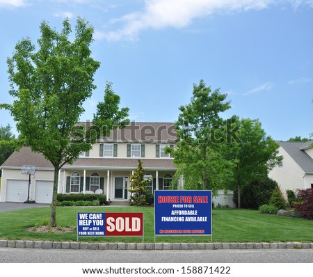 Sold Real Estate Sign Let Us Help you Buy Sell Home Beautiful Suburban Home Landscaped Blue Sky Clouds Residential Neighborhood USA