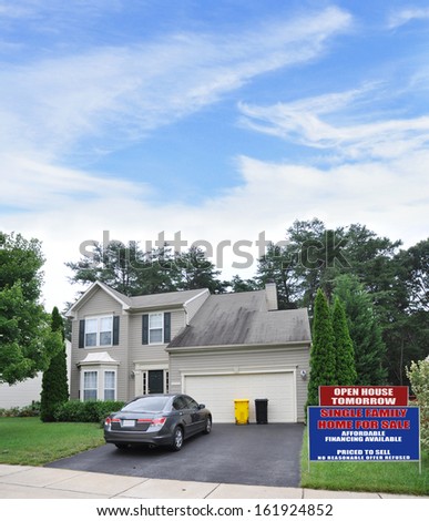Real Estate For Sale Open House Sign Front yard Lawn Suburban Home Parked Car Blacktop Driveway Residential Neighborhood USA Blue Sky Clouds