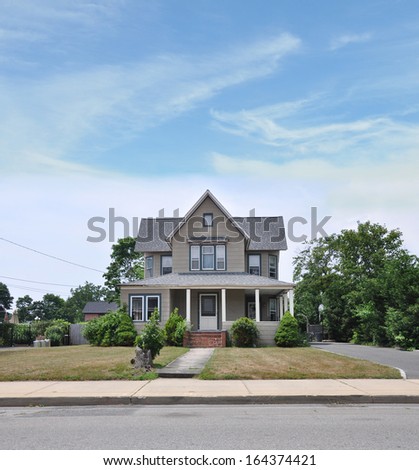 Suburban Victorian Style Home Exterior Front Yard Dry Grass Blue Sky Clouds Residential Neighborhood USA