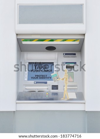 Please take your Card Protect your Identity Mannequin Reading Newspaper on protecting identity walking across bank automatic teller machine