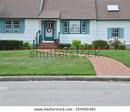 Suburban House front Landscaped with brick walkway flowers residential neighborhood USA