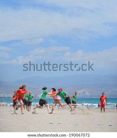ALICANTE, SPAIN - APR 27: Seville\'s Frisbee team Frisbillanes wearing green tee shirt is competing in the 1st Ultimate Frisbee Tournament Apr 26-27 held on San Juan Beach in Alicante. April 27, 2014.