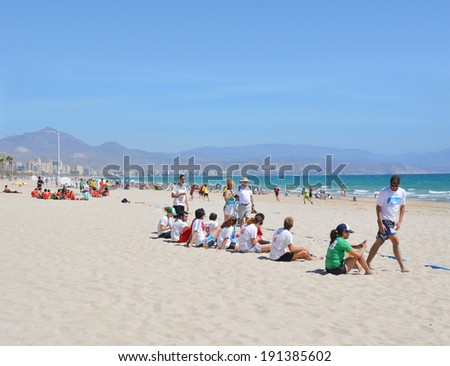 ALICANTE, SPAIN - APR 27: Murcielagos frisbee team (white/red shirts) watching Alicante\'s Frisbillanes play in the Ultimate Frisbee Tournament game hosted on San Juan beach in Alicante Apr 27, 2014.