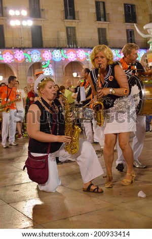 ALICANTE, SPAIN - JUN 23: So What! band played music for the crowd gathered on town hall sq. where the Hogueras Bonfire Festival\'s 59th International folk parade ended. Alicante, Jun 23, 2014.