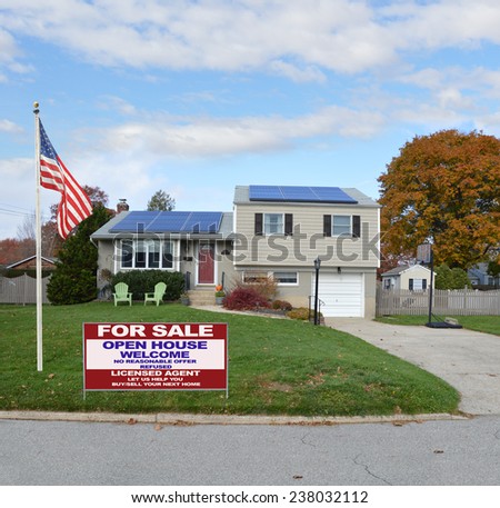 American flag pole Real Estate for sale open house welcome sign Suburban high ranch house autumn day residential neighborhood blue sky clouds USA