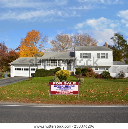 Real Estate for sale open house welcome sign Suburban High Ranch home autumn day residential neighborhood blue sky clouds USA
