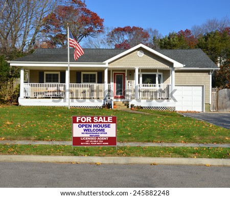 American flag pole Real estate for sale open house welcome sign Suburban Ranch style home with porch sunny autumn day residential neighborhood clear blue sky USA