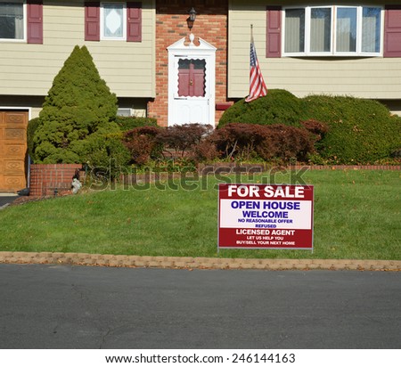 Real estate for sale open house welcome sign Suburban High Ranch brick landscaped home with cobble stone curb sunny autumn day residential neighborhood USA