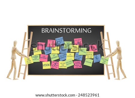 Mannequins holding (write down your goals and think outside the box) written on post it note climbing ladder to add to blackboard filled with Brainstorming ideas isolated on white background