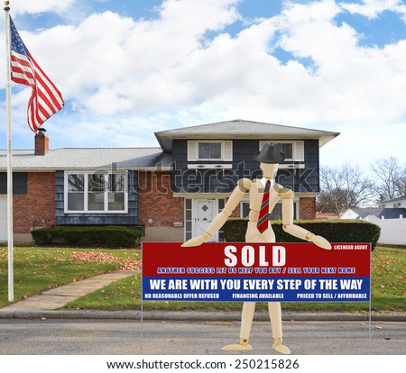American flag pole Real estate sold (another success let us help you buy sell your next home) sign Suburban high ranch brick home autumn blue sky clouds day residential neighborhood USA