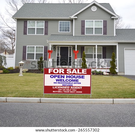 Real estate for sale open house welcome sign Suburban McMansion style home overcast day residential neighborhood USA