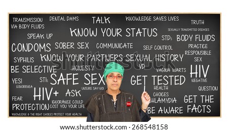 Teacher wearing Tested button pointing to Safe Sex Blackboard: Get Tested, Know Your Status, Get Facts, Protection, Question, Responsible Sex, Truth, Be Aware, Unsure Say No, Sober Sex