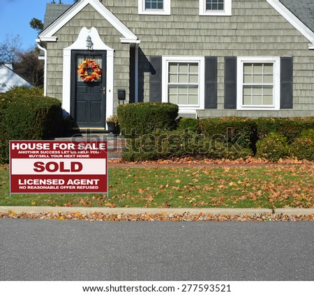 Real estate sold (another success let us help you buy sell your next home) sign Close up of Beautiful Home Leaf wreath Sunny autumn day residential neighborhood USA