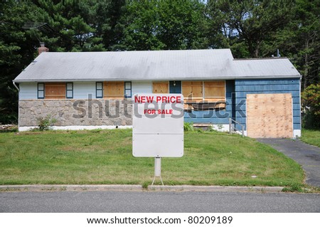 For Sale Sign in front of Boarded Abandon Blue Shingle Residential Suburban Home Quick Sale