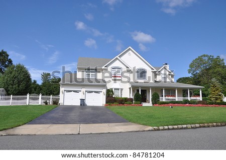 Suburban Luxury Home Blacktop Driveway with Trash Can Manicured Landscaped Front Yard