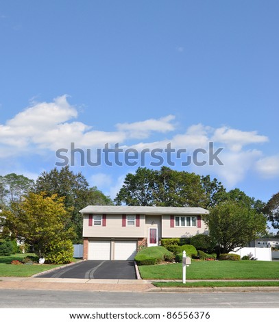 Ranch Style Suburban Two Story Two Car Garage Home in Residential Neighborhood on Sunny Blue Sky Day