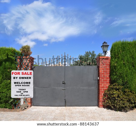 For Sale by Owner Sign in Front of Home Gate in Suburban Residential Neighborhood under blue sky