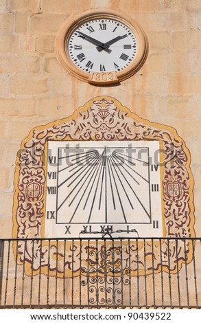 Clocks Circle and Sundial on Ancient Spanish Architecture Church Wall in Novelda