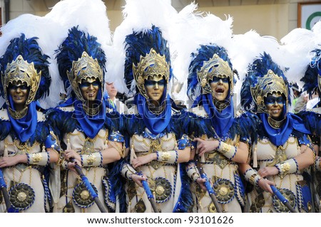 MURO ALCOY, SPAIN - MAY 7:   Legion of women wearing Moors warrior costumes holding hands marching in Moros y Cristianos parade commemorating reconquista period battles/combats. Muro Alcoy May 7,2011.
